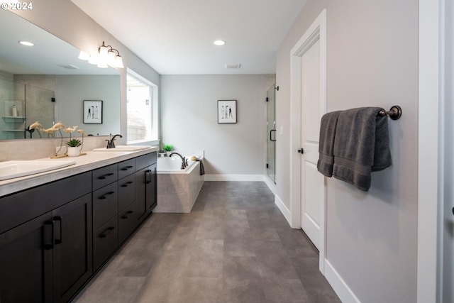 bathroom with vanity and independent shower and bath