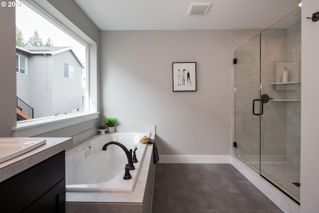 bathroom with vanity and separate shower and tub