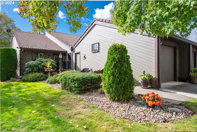 view of home's exterior featuring a yard and a garage