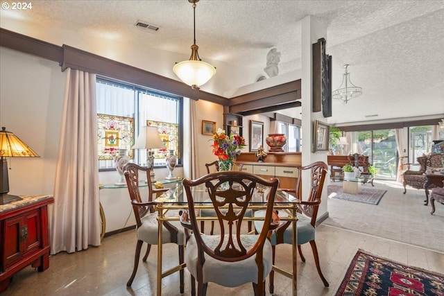 dining space with a textured ceiling