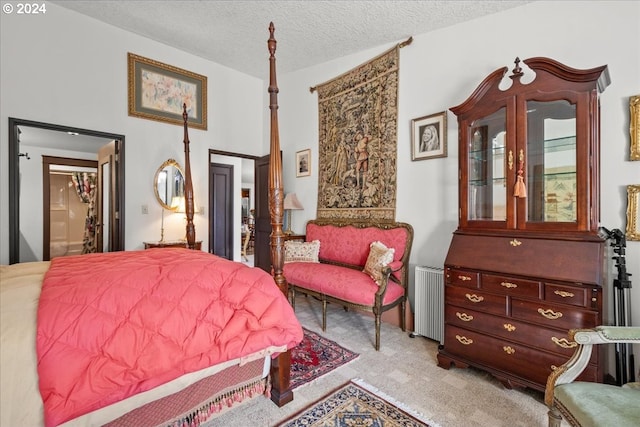 bedroom with radiator, light carpet, and a textured ceiling