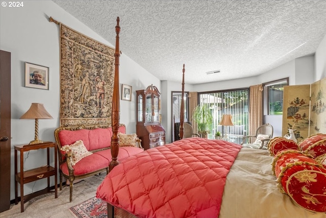 bedroom with light carpet and a textured ceiling