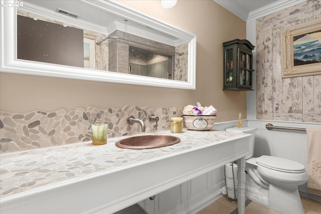 bathroom with toilet, ornamental molding, sink, a shower with shower curtain, and tile patterned flooring