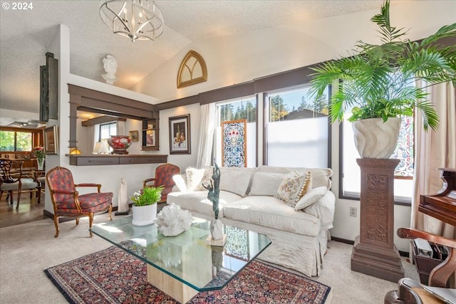 carpeted living room featuring lofted ceiling, a textured ceiling, and a notable chandelier