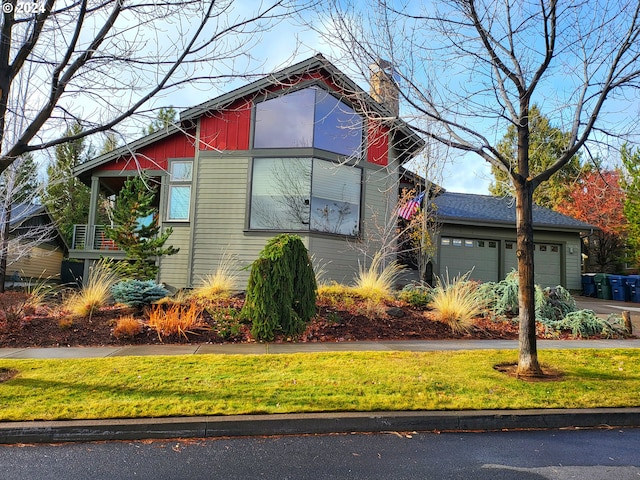 view of side of home with a yard and a garage