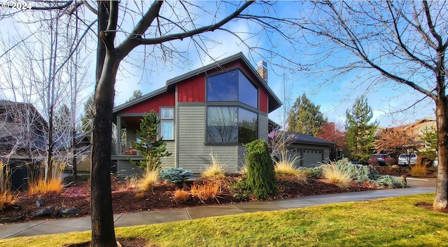 view of side of property with a garage and a yard