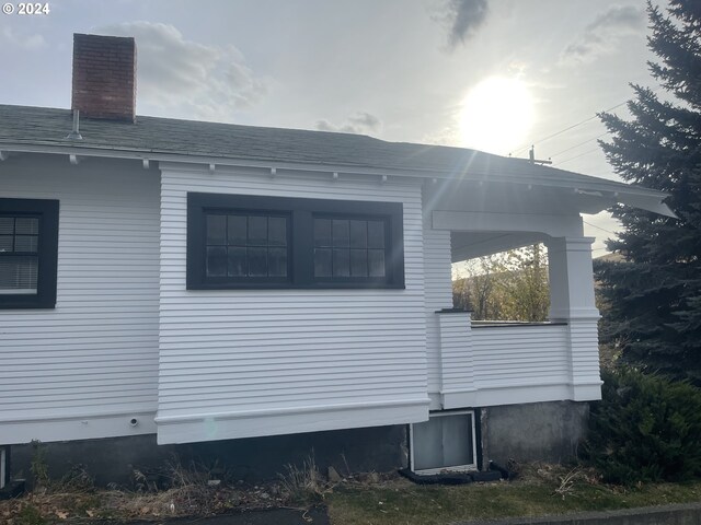 240 N Court St, Heppner, OR 97836 - view of property exterior with a chimney and a shingled roof