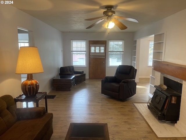 240 N Court St, Heppner, OR 97836 - living area with wood finished floors, a ceiling fan, baseboards, and a wood stove
