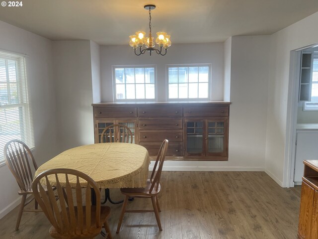 240 N Court St, Heppner, OR 97836 - dining room with a chandelier, baseboards, and wood finished floors