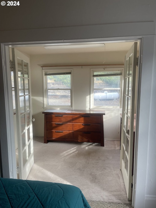 carpeted bedroom with french doors