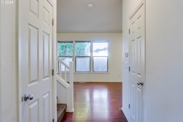 hall with dark wood-type flooring