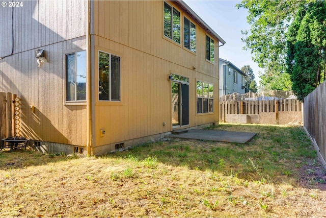 rear view of property featuring a lawn