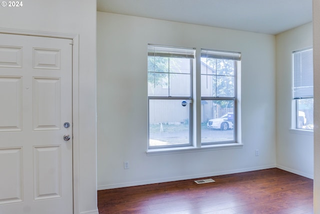 empty room featuring dark hardwood / wood-style flooring