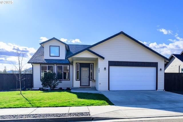 view of front of property with a shingled roof, a front lawn, fence, concrete driveway, and an attached garage