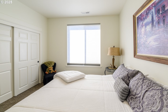 bedroom with visible vents and carpet floors