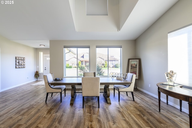 dining room featuring wood finished floors and baseboards