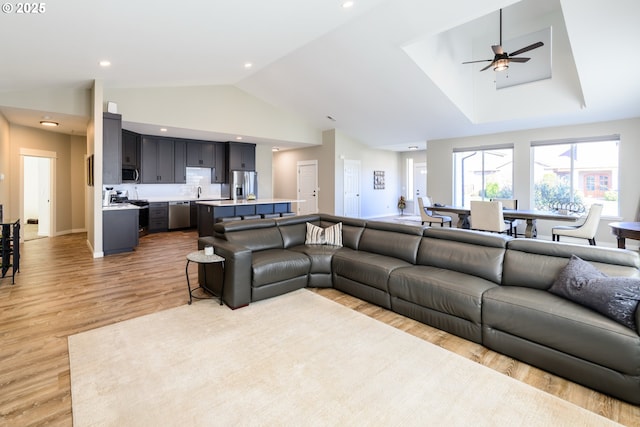 living area featuring high vaulted ceiling, a ceiling fan, recessed lighting, light wood finished floors, and baseboards