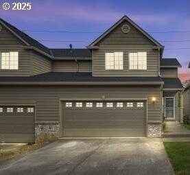 view of front of property featuring cooling unit and a garage