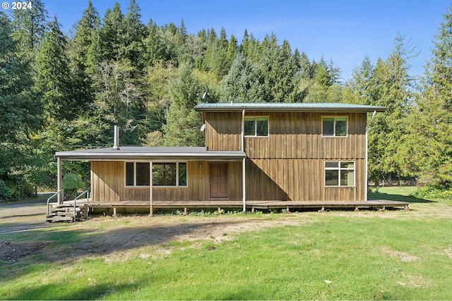 back of house featuring a yard