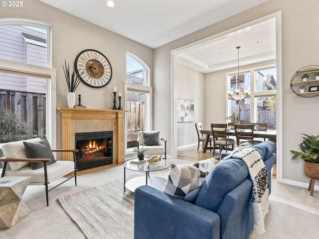 living room with light carpet and a chandelier