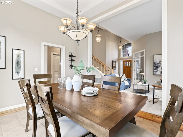 dining area with vaulted ceiling with beams, a chandelier, and light tile patterned flooring