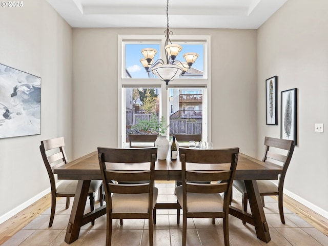 dining area with wood-type flooring and a notable chandelier