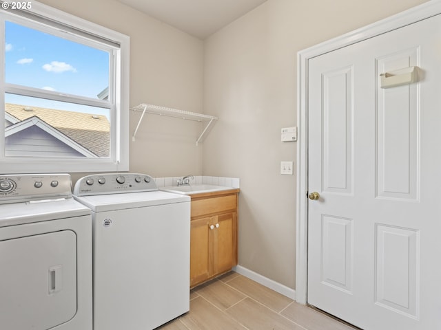 laundry room with sink, cabinets, and washing machine and dryer