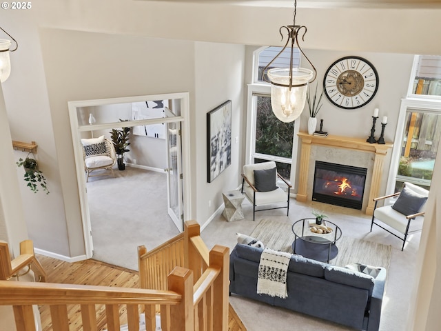 living room featuring light wood-type flooring and a premium fireplace