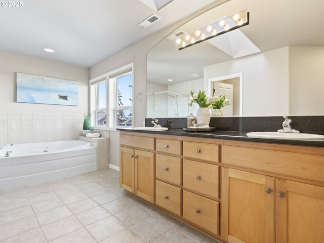 bathroom featuring vanity, shower with separate bathtub, and tile patterned floors