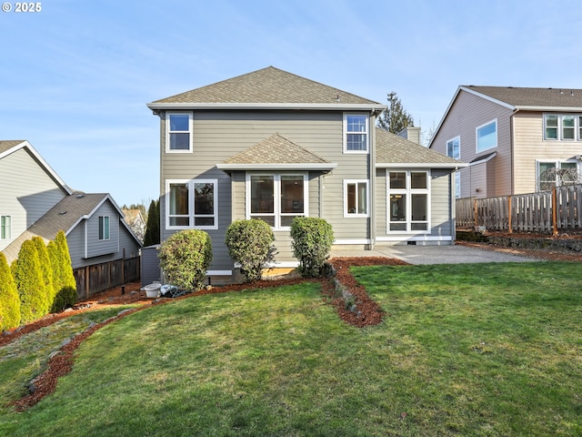 rear view of property featuring a patio and a lawn