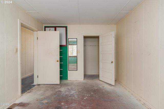 unfurnished bedroom featuring concrete flooring