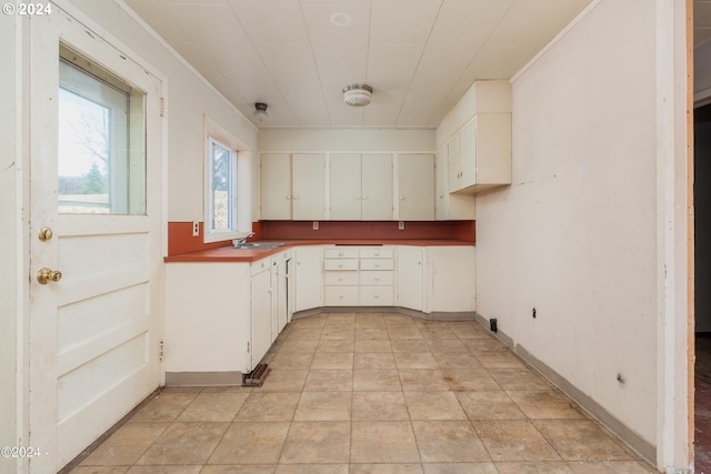 kitchen featuring white cabinetry and sink