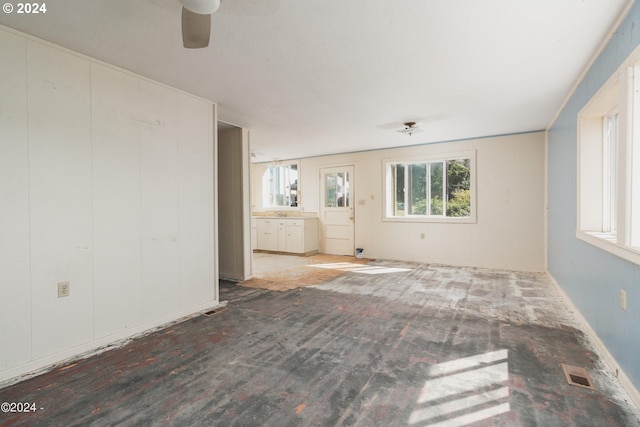 unfurnished living room with ceiling fan and hardwood / wood-style floors