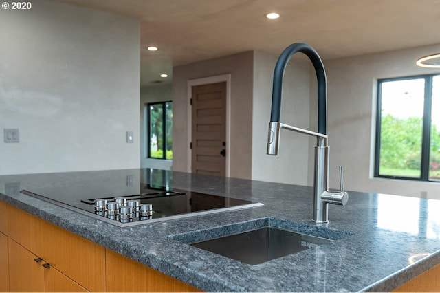 kitchen featuring dark stone countertops and sink