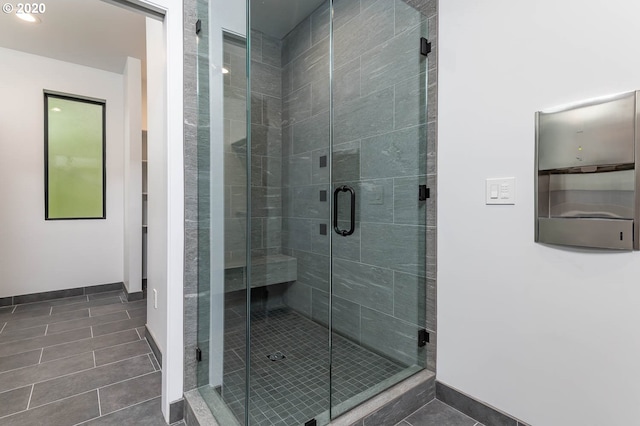 bathroom featuring tile patterned flooring and a shower with shower door