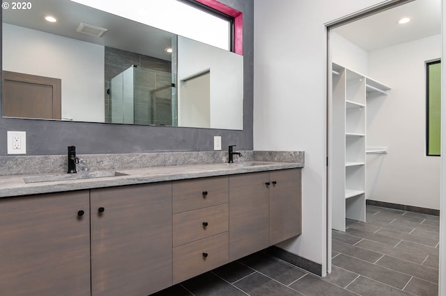 bathroom featuring vanity, tile patterned floors, and an enclosed shower