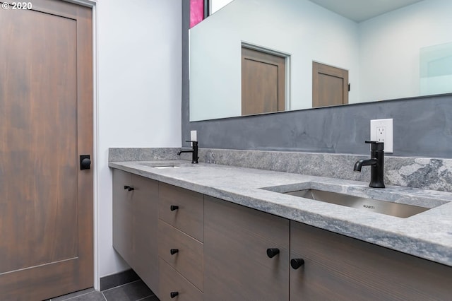 bathroom with tile patterned floors and vanity