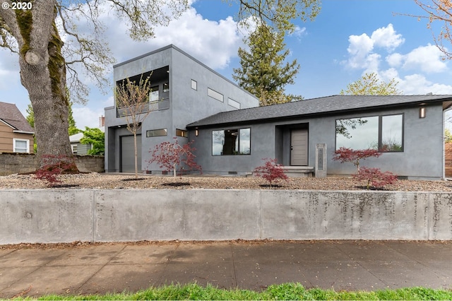 contemporary home featuring a garage and a balcony