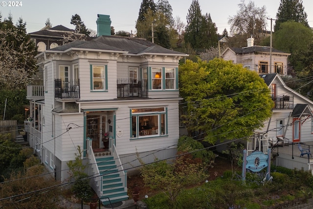 847 Exchange St Unit 0 817-, Astoria, OR 97103 - italianate-style house with a balcony, a chimney, and stairway