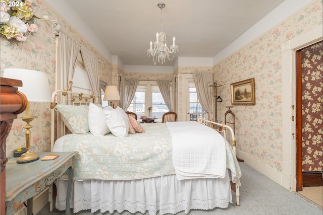 bedroom with an inviting chandelier and carpet