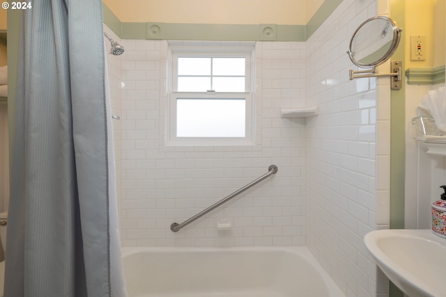 bathroom with shower / tub combo and sink