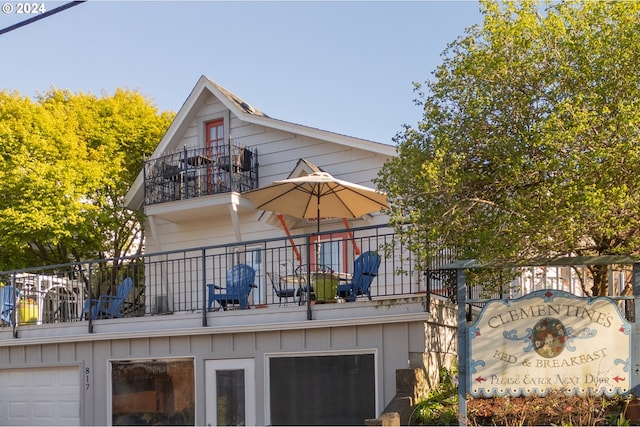 exterior space featuring a garage and a balcony