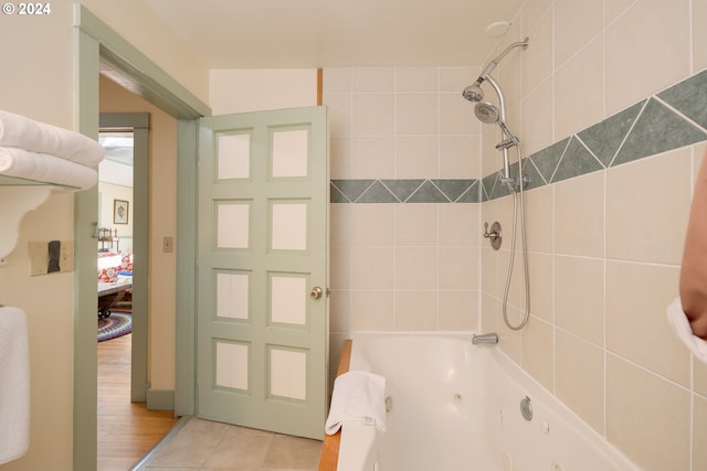 bathroom featuring tile flooring and tiled shower / bath combo