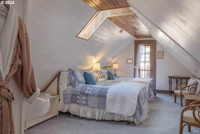 carpeted bedroom with lofted ceiling with skylight and wooden ceiling