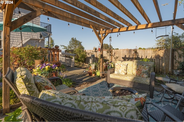 view of patio featuring an outdoor fire pit, a wooden deck, and a pergola