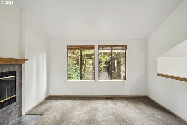 unfurnished living room featuring carpet and a fireplace