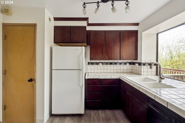 kitchen featuring tile counters, white fridge, sink, and dark wood-type flooring