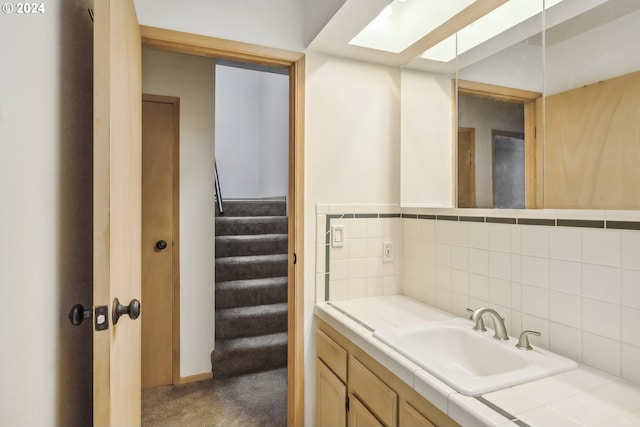 bathroom with vanity and backsplash