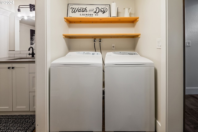 washroom with washer and dryer and sink