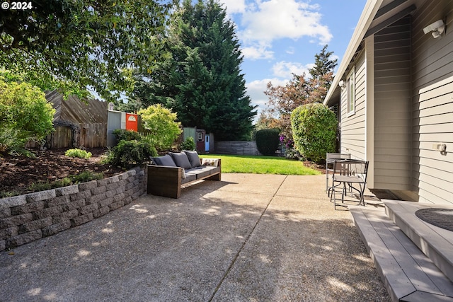 view of patio / terrace featuring a storage unit and an outdoor living space